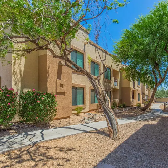 Apartment Complex Exterior Exterior view of an apartment complex with trees and shrubs.