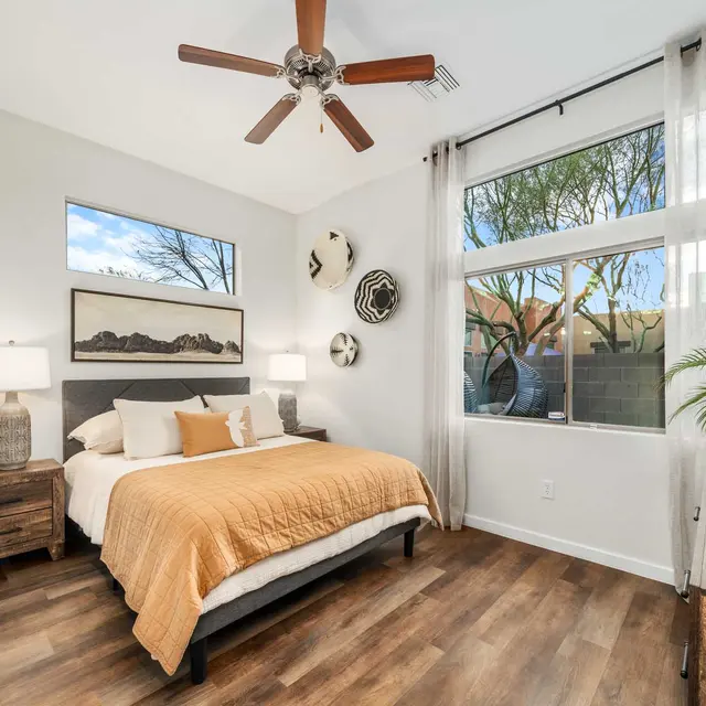 Primary bedroom with natural light and ceiling fan at Avilla Marana in Marana, AZ
