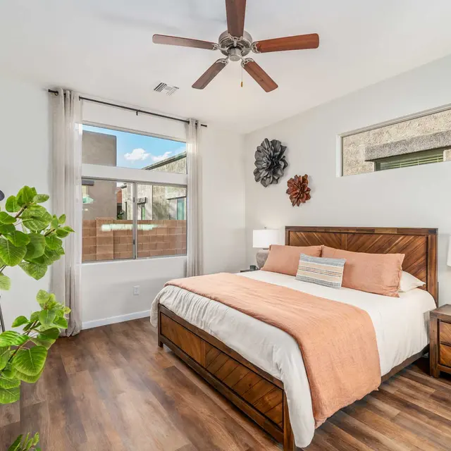 Primary bedroom with warm natural light and modern finishes at Avilla Marana