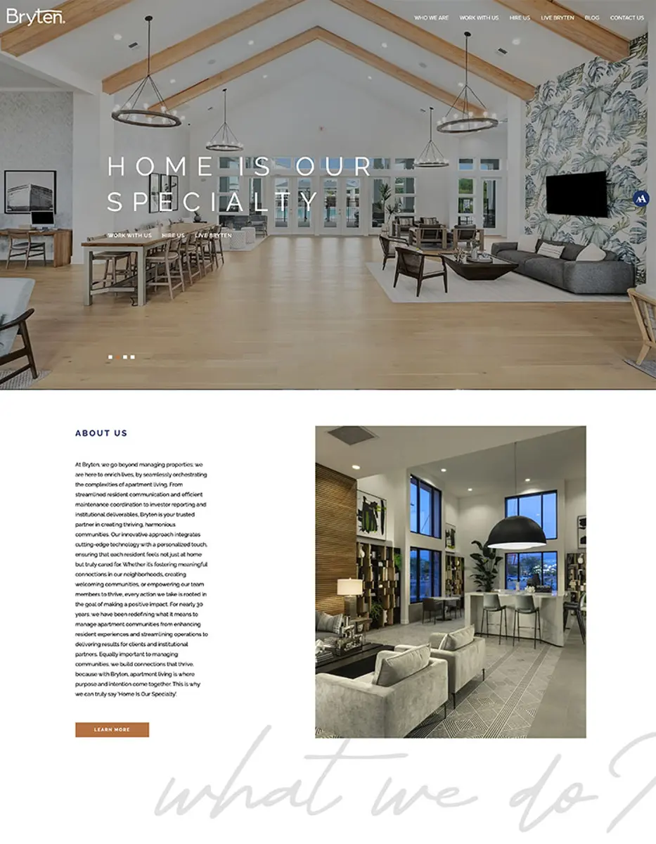 A modern and stylish interior of a living space showcasing an open design with large windows, wooden beams, and elegant furnishings. The area is bright and inviting, featuring seating arrangements and decorative elements.