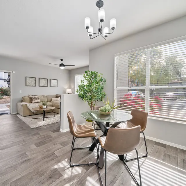 Bright dining area with large windows and open layout apartment design at Bear Canyon Apartments in Tucson, AZ