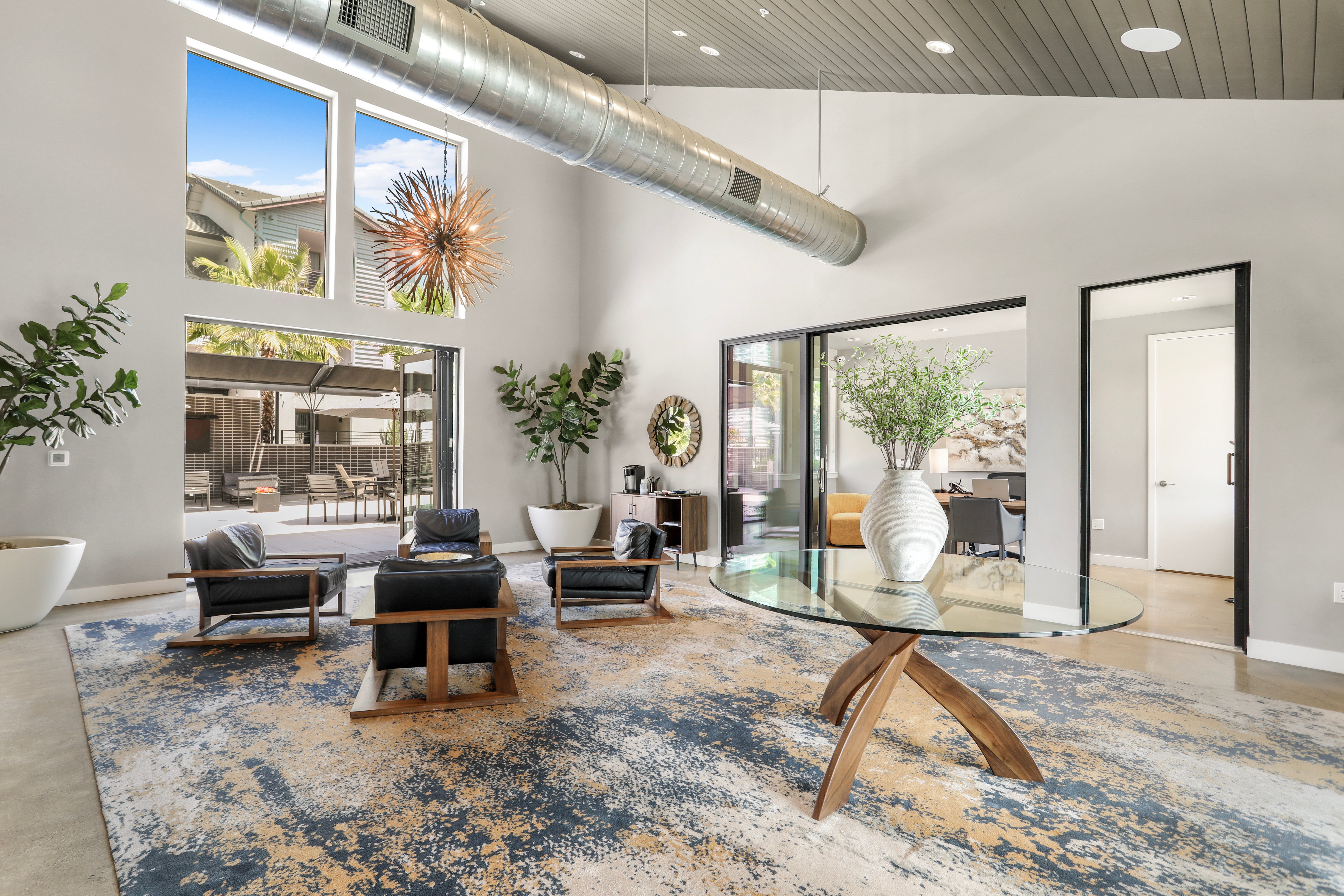 Modern Lobby Interior Bright modern lobby with large windows, stylish furniture, and a decorative rug.
