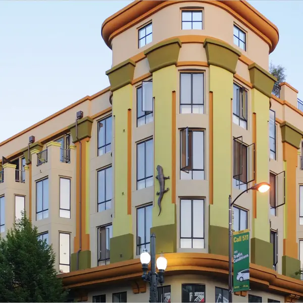 Colorful hotel building with a modern design and large windows, featuring a unique architectural style.