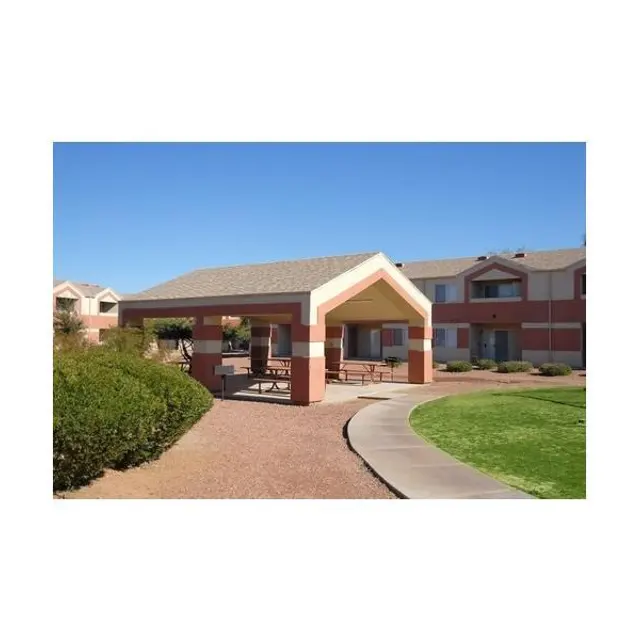 Outdoor shelter area in a residential community with a path and surrounding greenery.