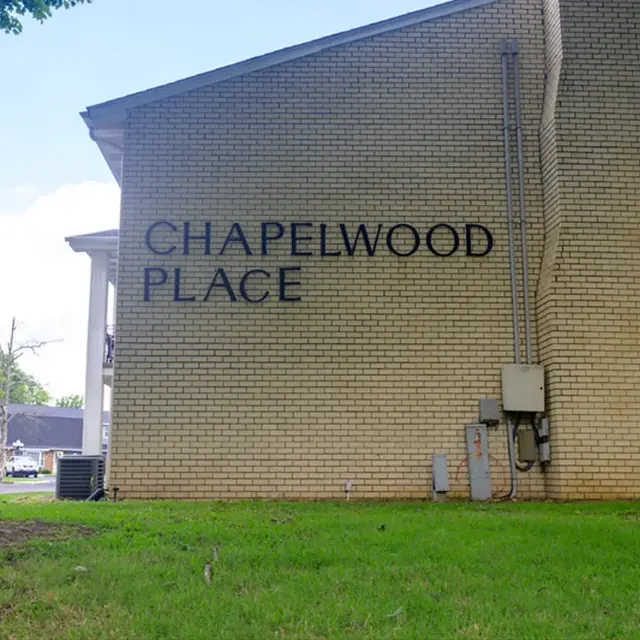 Side view of a building with the sign 'Chapelwood Place' on the wall