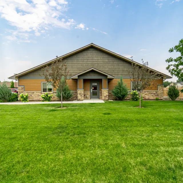 Modern House Exterior A modern house exterior featuring a combination of stone and wood siding, with landscaped greenery surrounding it.