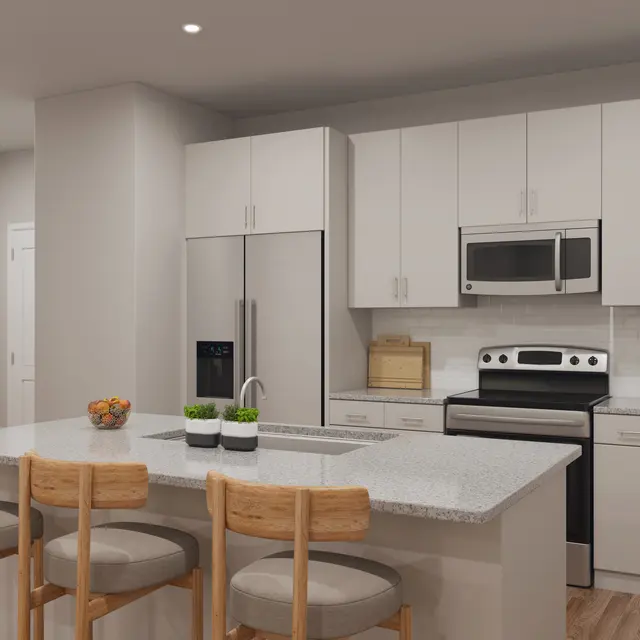 A modern kitchen featuring a large island with bar stools, stainless steel appliances, and white cabinetry.