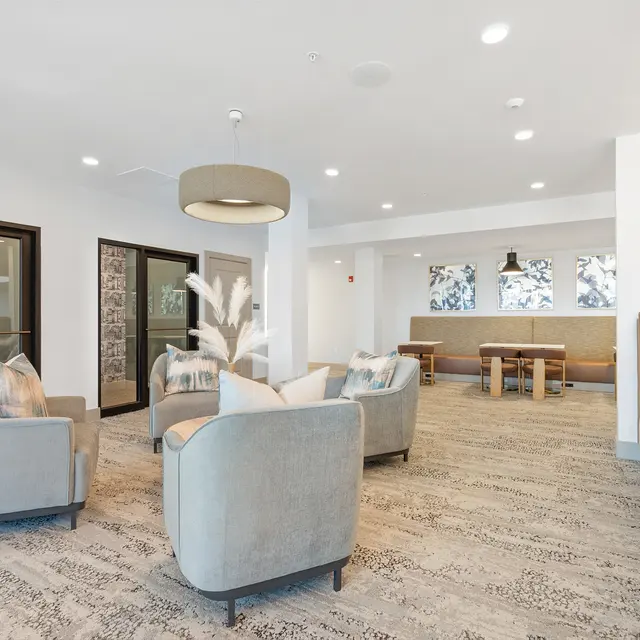 A modern lounge area featuring stylish seating and decorative elements.