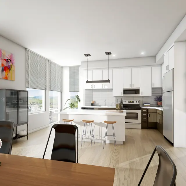 Modern kitchen with white cabinets, stainless steel appliances, a dining table, and large windows offering natural light.