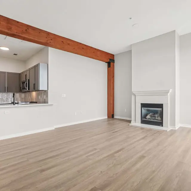 Modern Living Room Design Spacious modern living room with hardwood flooring, a fireplace, and exposed wooden beams