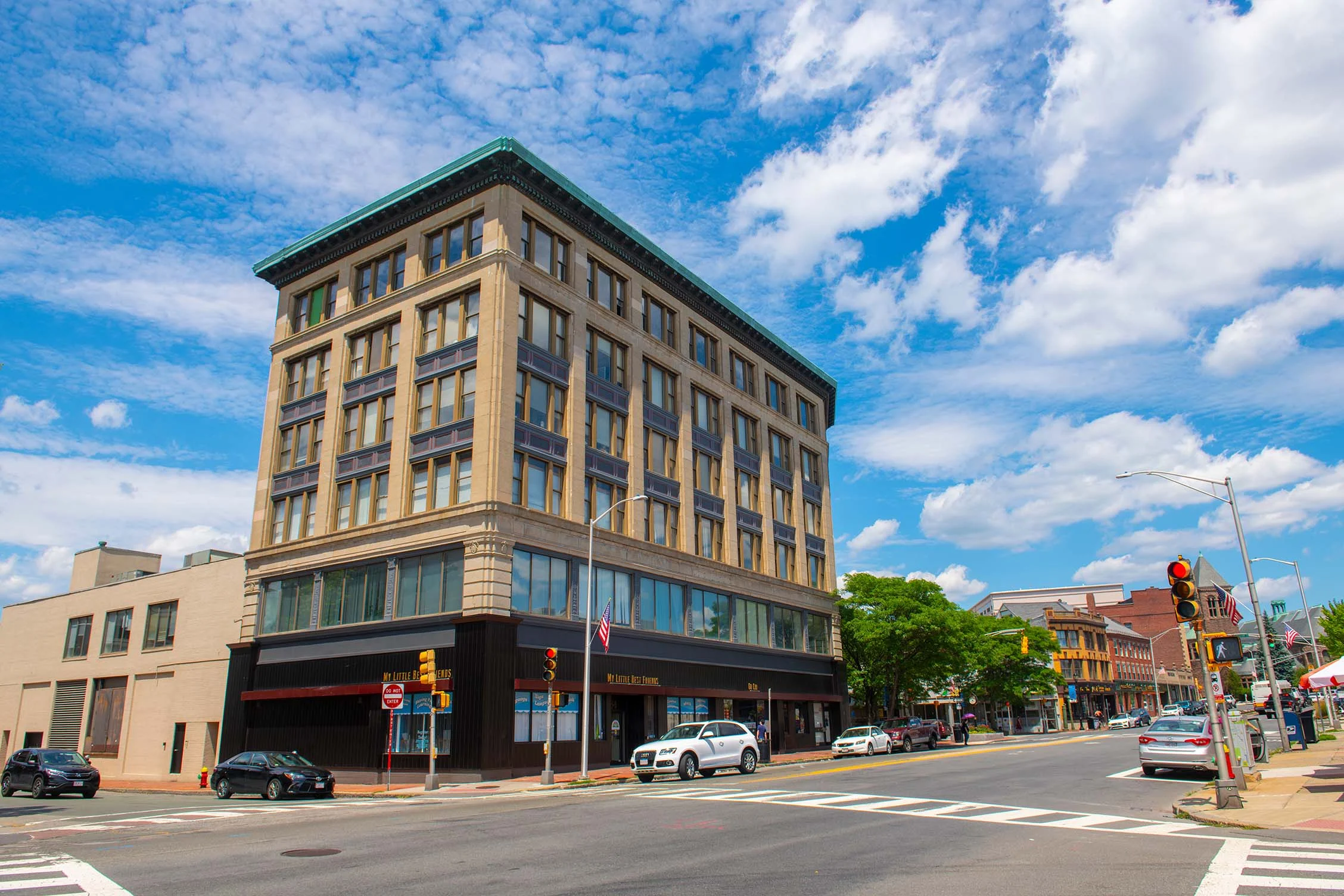 Historic Building in Downtown A historic multi-story building in a downtown area with a blue sky and fluffy clouds overhead.