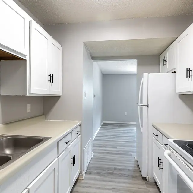 Modern Kitchen Design A modern kitchen featuring white cabinets, a double sink, and a stove in a clean design.