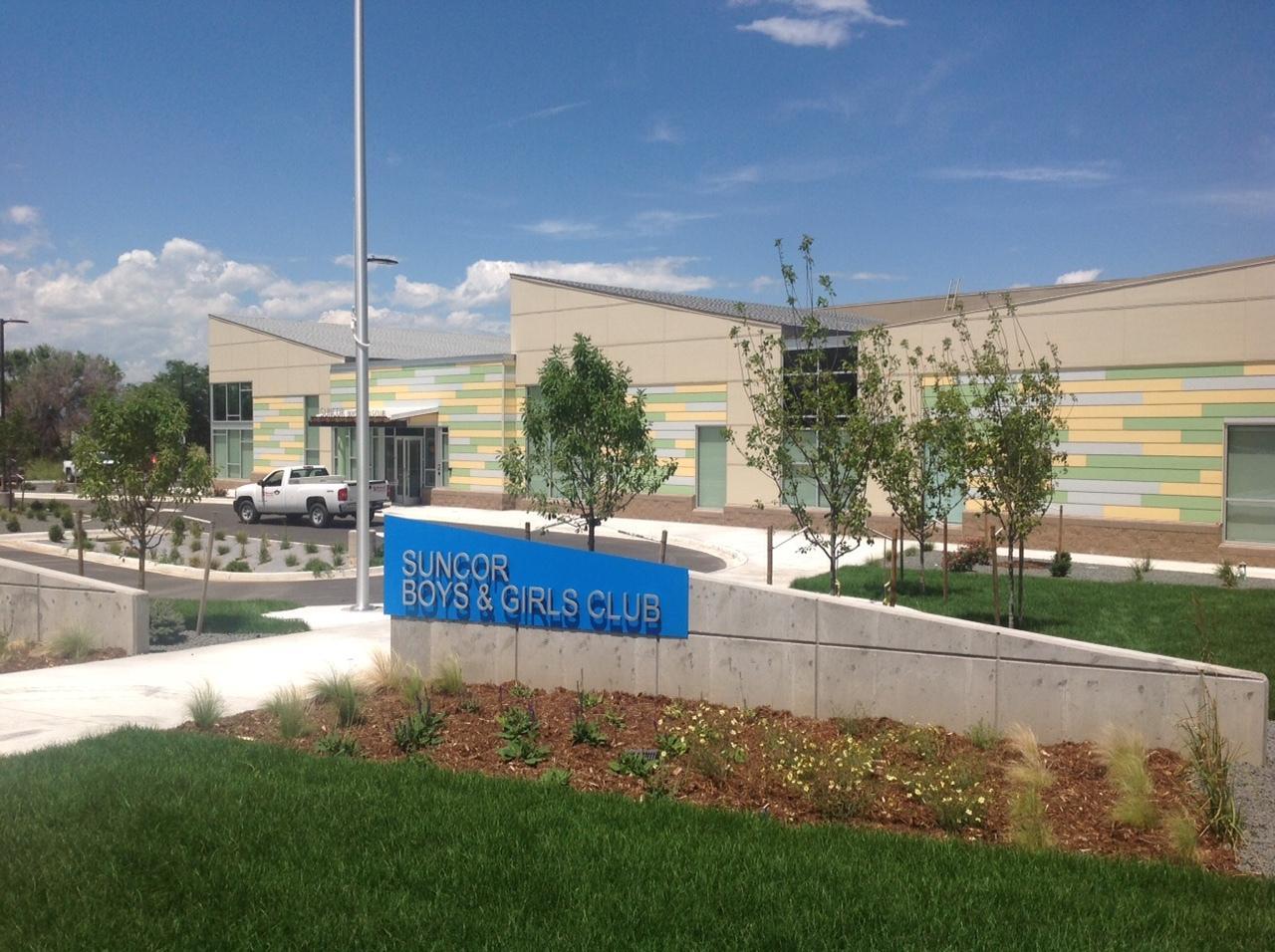 Suncor Boys & Girls Club Building Exterior view of the Suncor Boys & Girls Club building with colorful walls and landscaping.