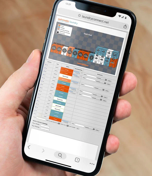 Laundry Management Interface on Smartphone A smartphone displaying a laundry management interface with visual elements of washers and dryers, along with schedule and status information.