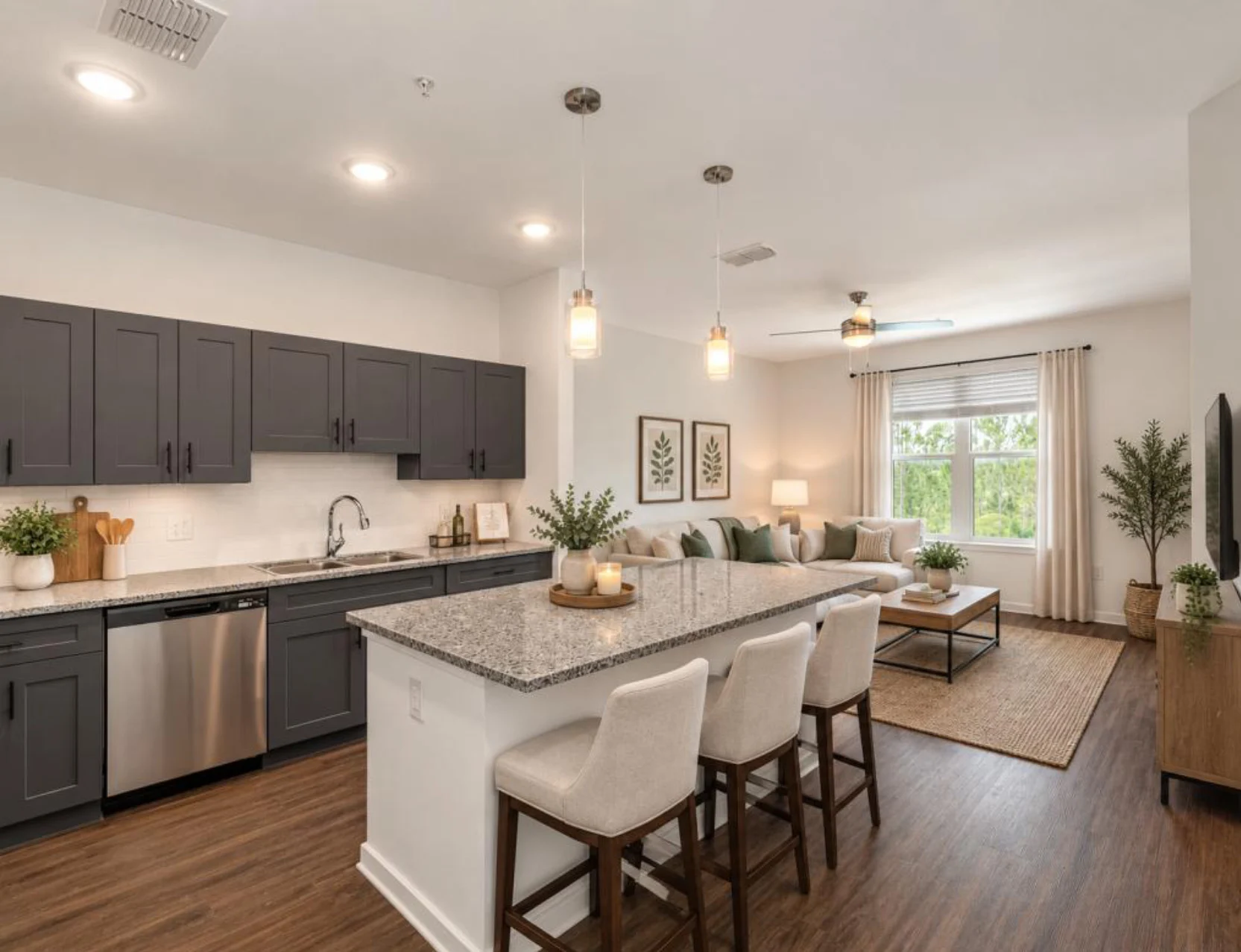 Modern Kitchen and Living Room A modern kitchen and living room layout featuring dark cabinets, stainless steel appliances, and a cozy seating area with green accents.