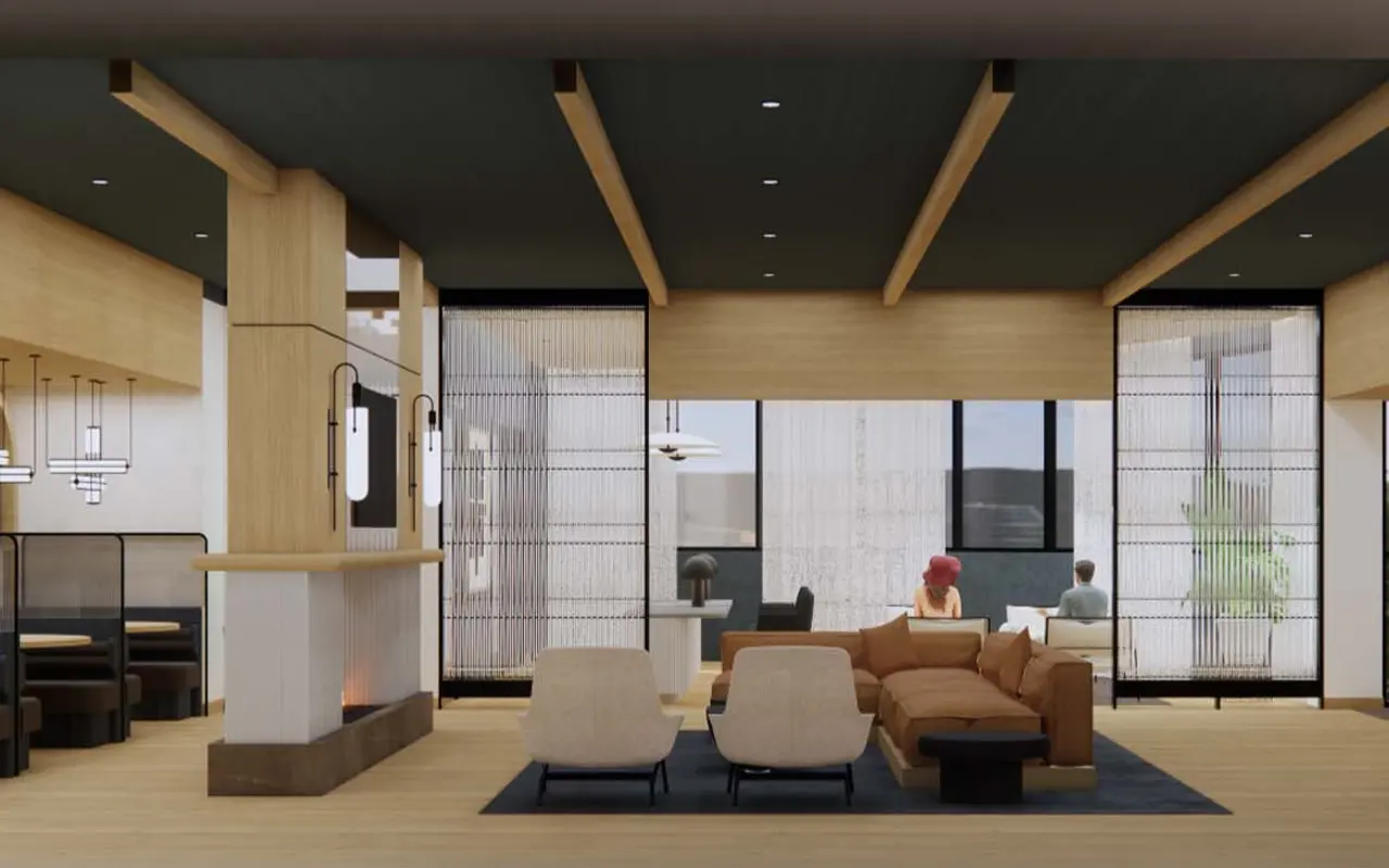 A modern lounge interior with wooden elements, comfortable seating, and large windows letting in natural light.