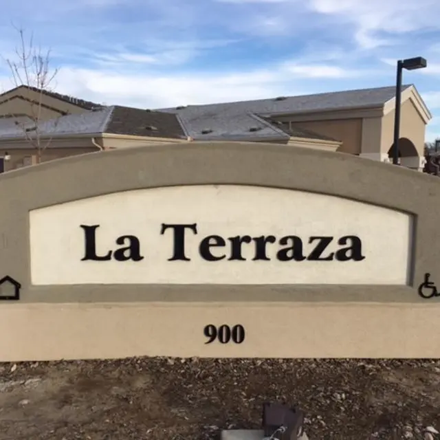 Sign for La Terraza with an address of 900 and symbols for home and accessibility.