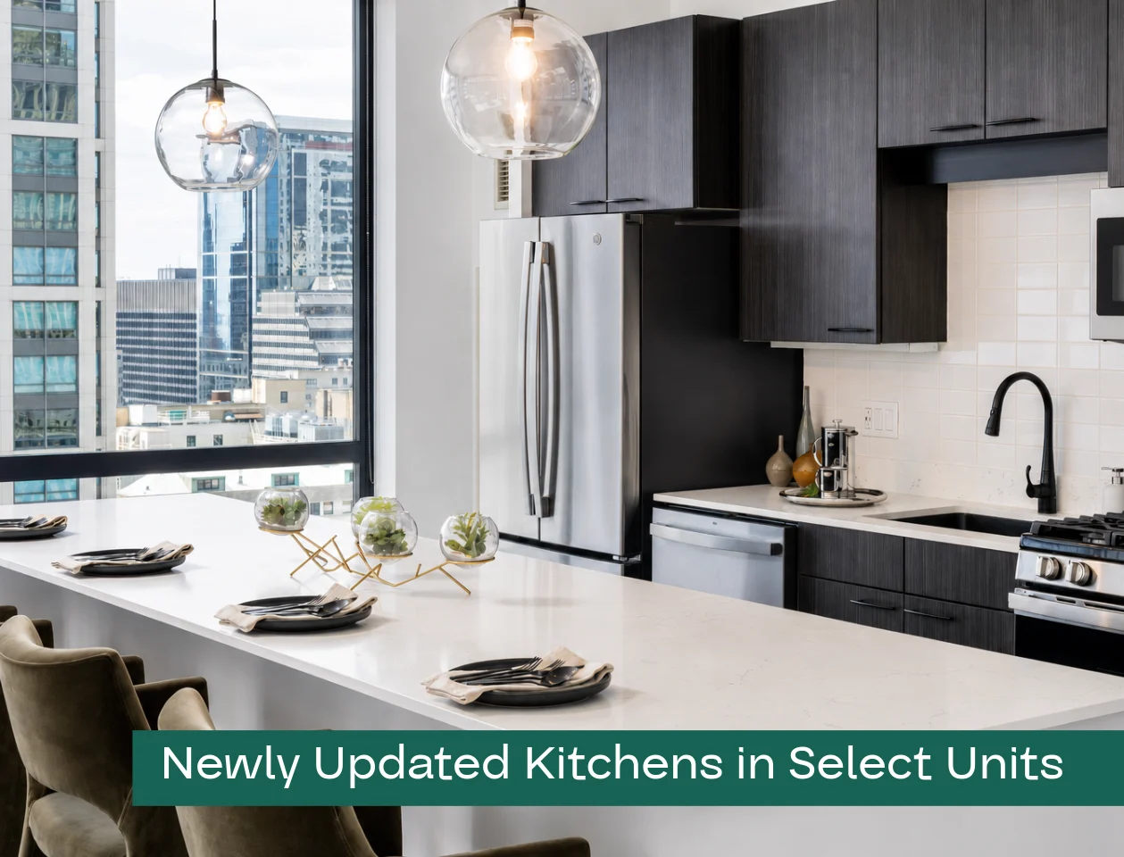 Stylish and Modern Kitchen Updates A modern kitchen with sleek cabinets and appliances, featuring a spacious white countertop, pendant lighting, and large windows providing a city view.