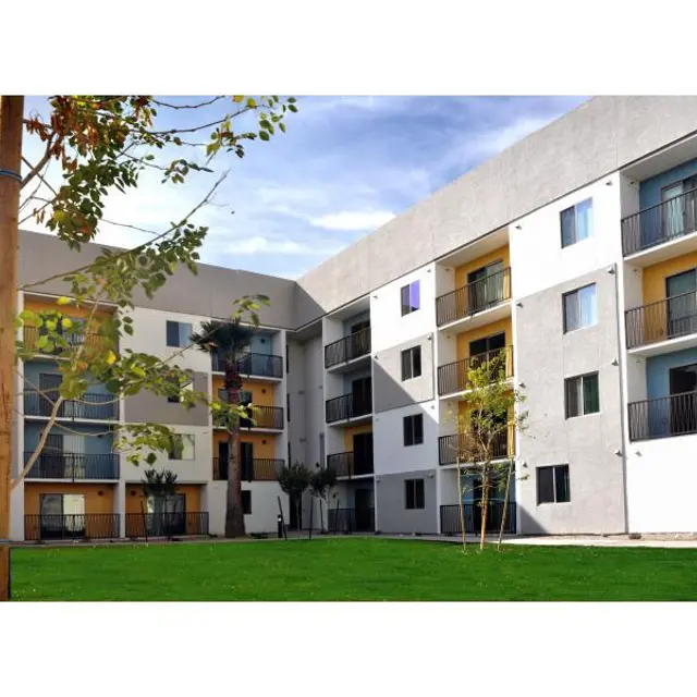 Modern Apartment Complex View of a modern apartment complex featuring balconies and green lawns.