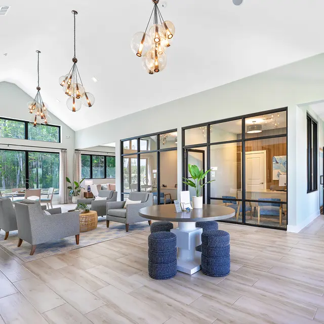 Spacious Modern Lounge Area A spacious and modern lounge area featuring large windows, comfortable seating, and elegant lighting fixtures.
