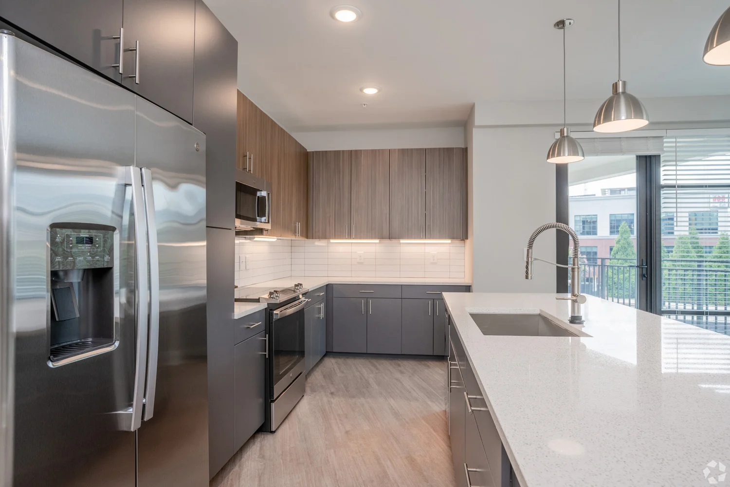 Stylish Modern Kitchen A modern kitchen featuring stainless steel appliances, wooden cabinets, and a spacious countertop with a sink.
