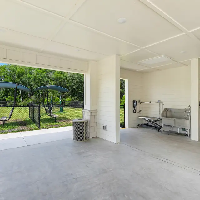 Outdoor Fitness Space An open community fitness area featuring exercise equipment and a view of a green park.