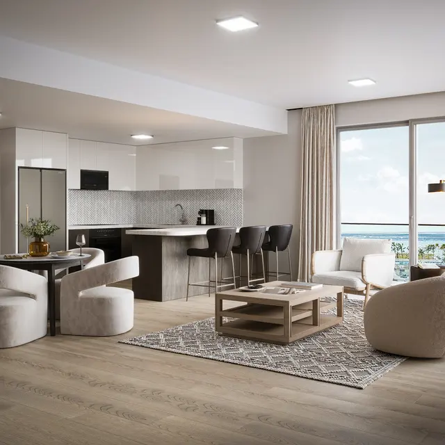 A modern apartment interior showcasing a living room and kitchen area with large windows letting in natural light. The decor is sleek and contemporary, featuring a cozy sofa, a dining table with rounded chairs, and a small coffee table on a patterned rug.