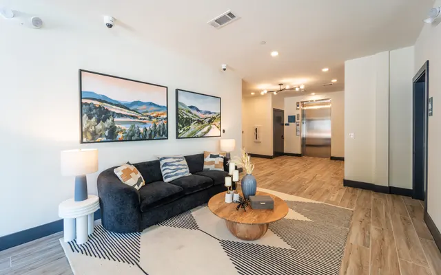A stylish and inviting modern living room featuring contemporary decor and artwork.