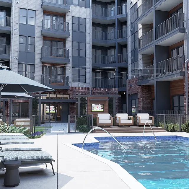 A modern apartment complex featuring a swimming pool surrounded by lounge chairs and umbrellas, with a courtyard view of the building's exterior.