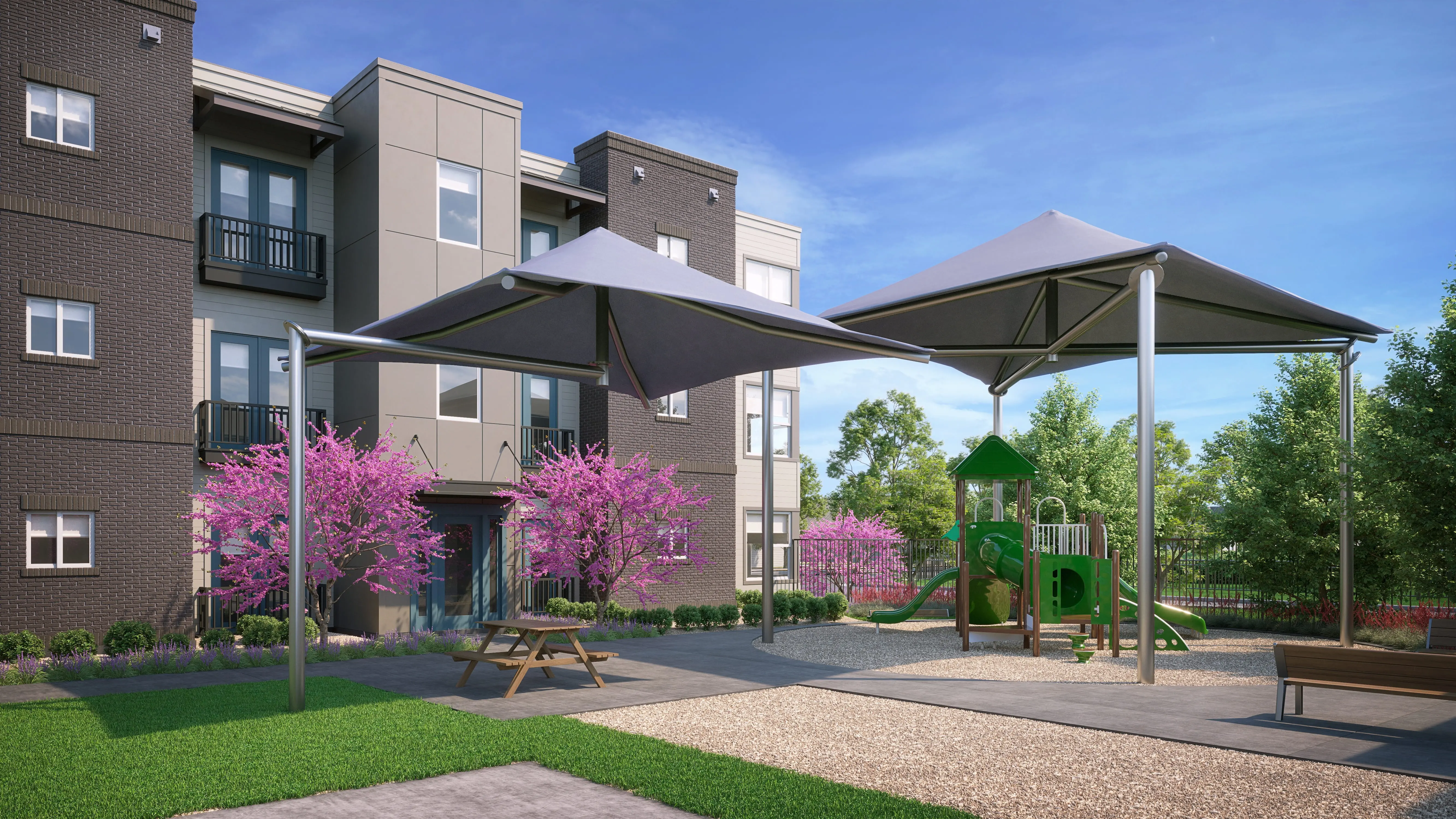 Playground Area with Shade Canopies Outdoor playground area with two large shade canopies, surrounded by blooming trees and featuring green playground equipment.