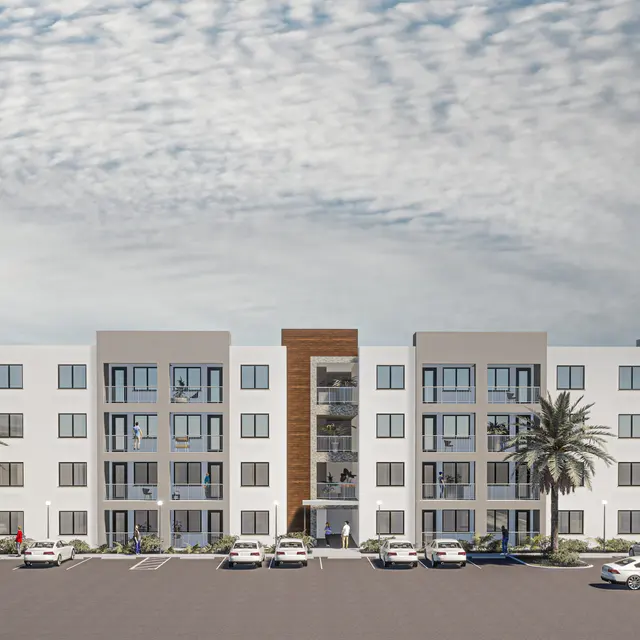 A modern apartment building with a three-story design featuring white walls, large windows, and palm trees. The facade includes a wooden accent panel, and parking spaces are visible in front.
