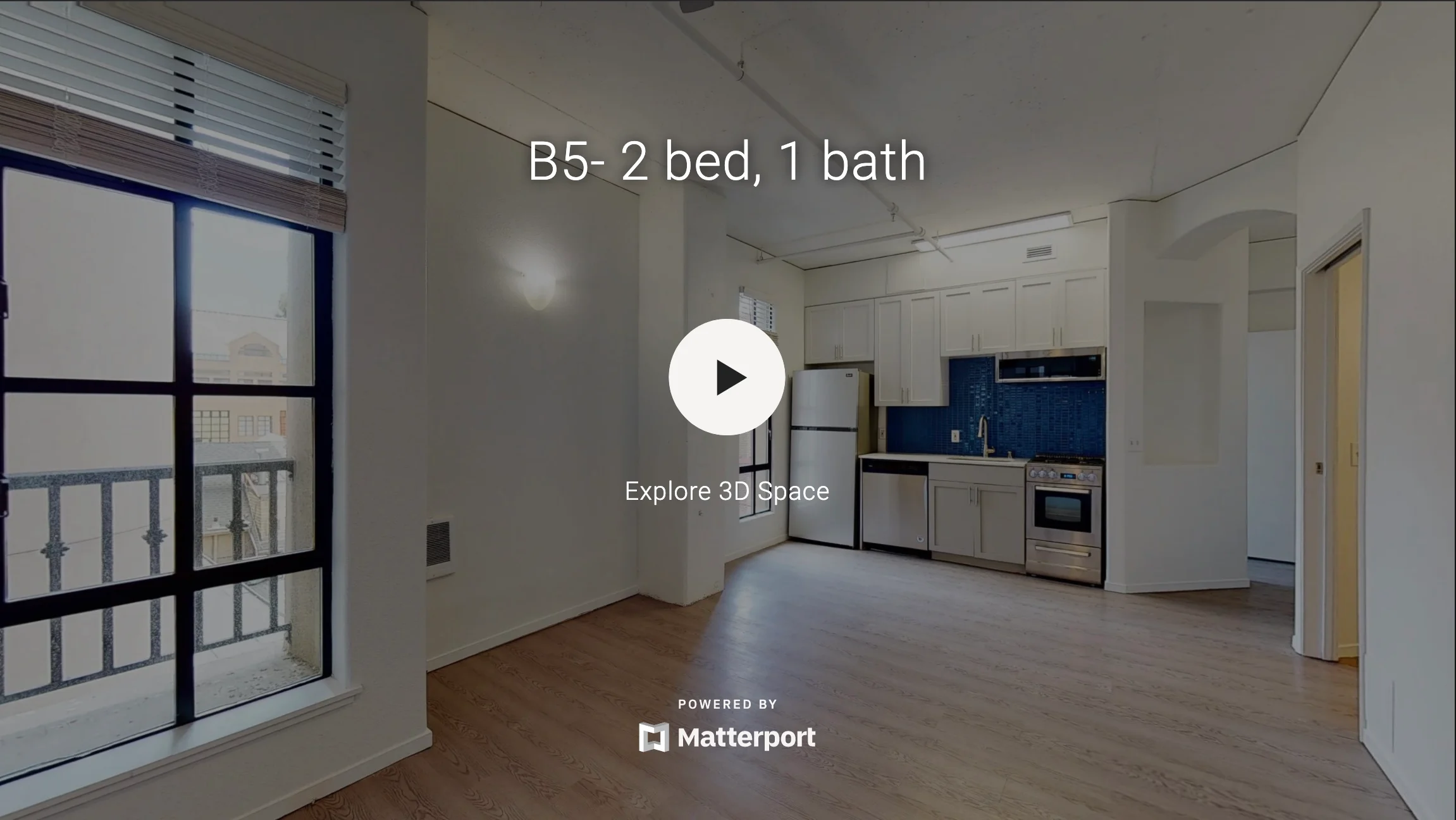 Interior view of a modern apartment with two bedrooms and one bathroom, showing a spacious layout and kitchen area.