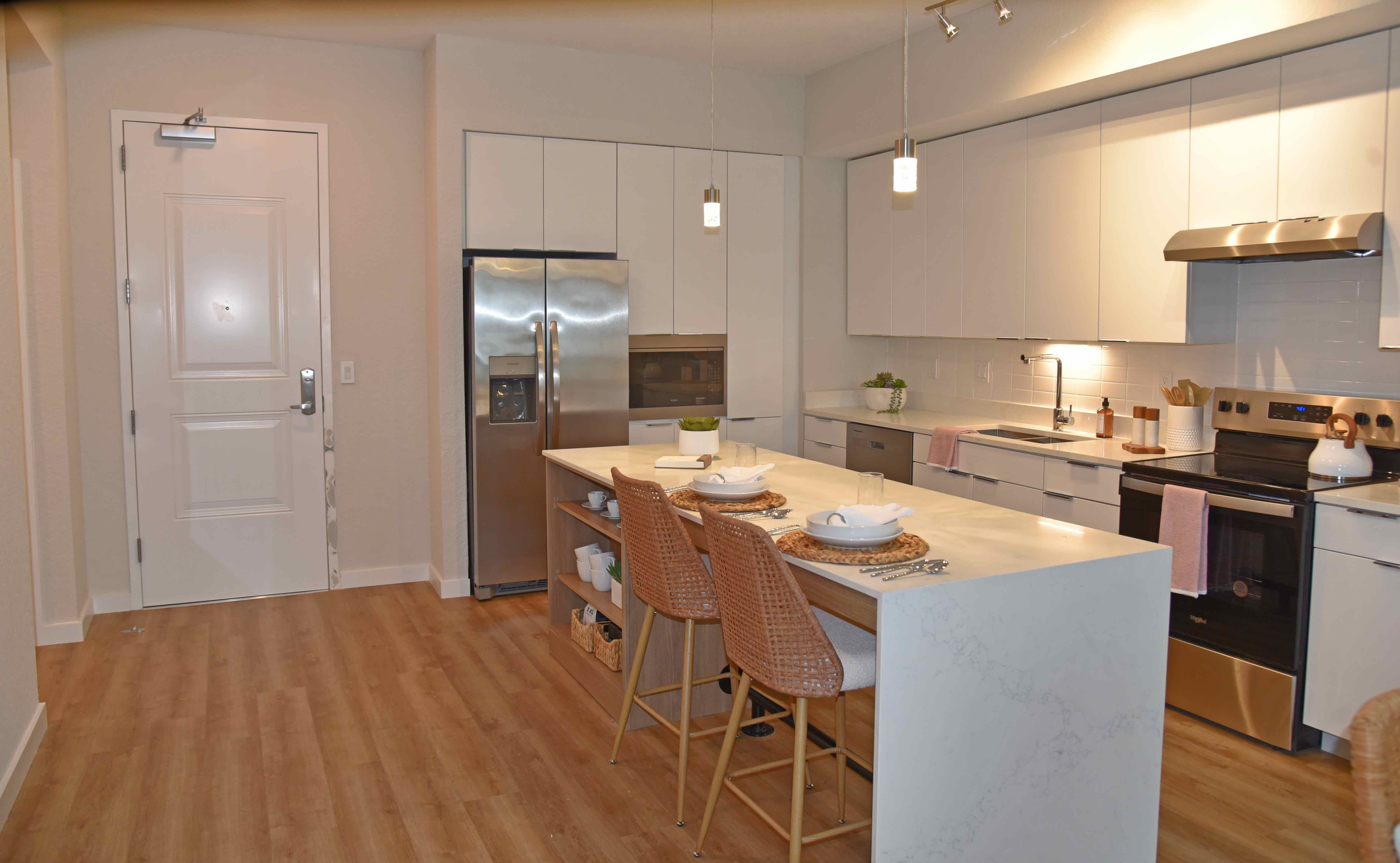 Modern Kitchen Interior A modern kitchen featuring a spacious layout with white cabinets, stainless steel appliances, and a large island with seating.