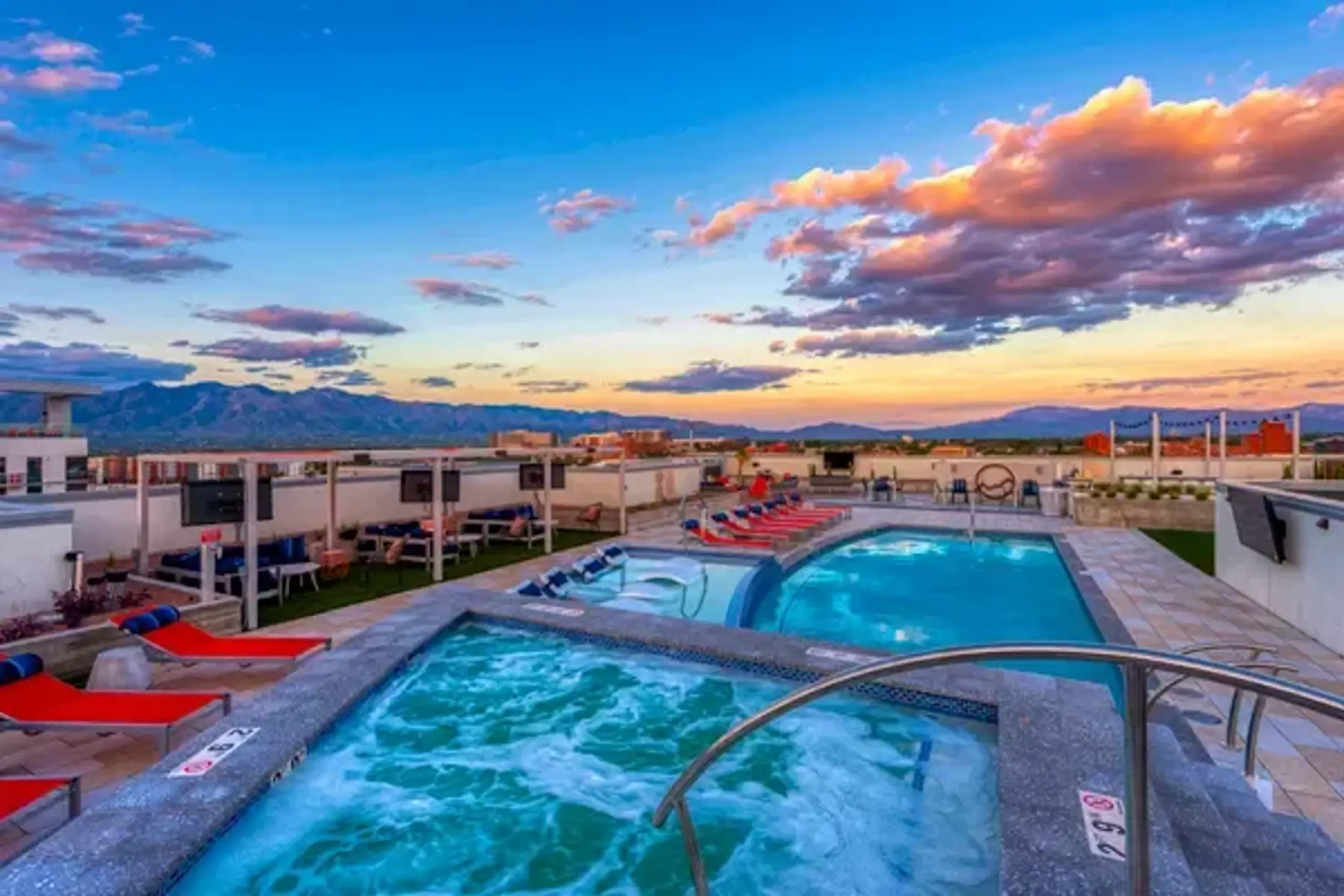 Rooftop Pool at Sunset Rooftop pool area with a hot tub and sunset view