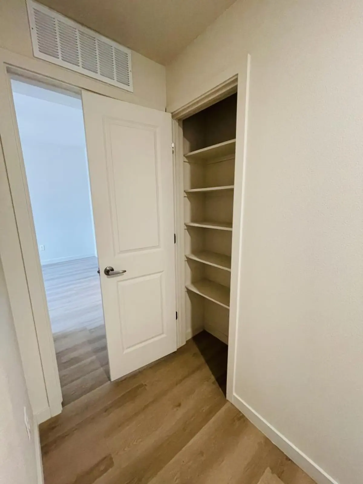 Hall linen closet with shelves.
