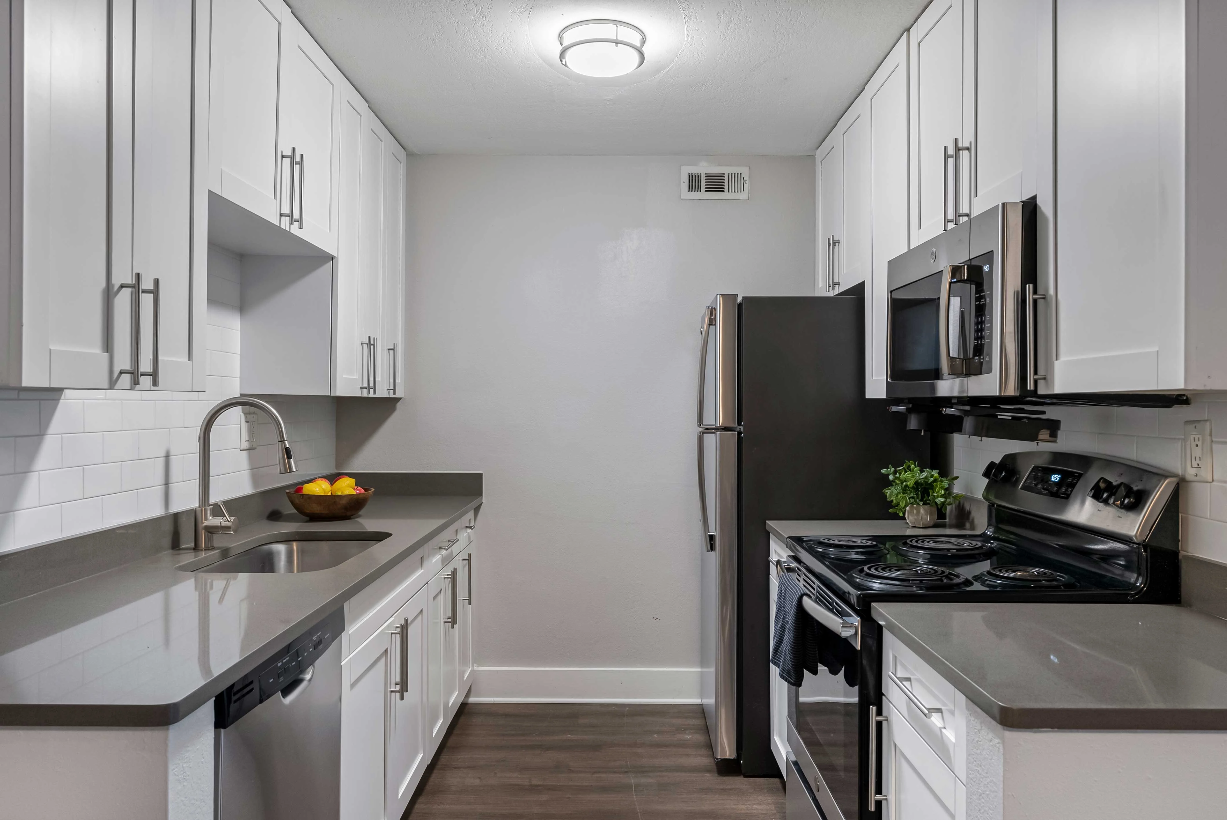 Modern Kitchen Design Inspiration A modern kitchen featuring white cabinetry, stainless steel appliances, and a gray countertop.