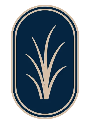 Grass Icon Emblem An emblem featuring stylized grass blades encased in an oval or rounded rectangle shape, with a dark blue background and beige design.