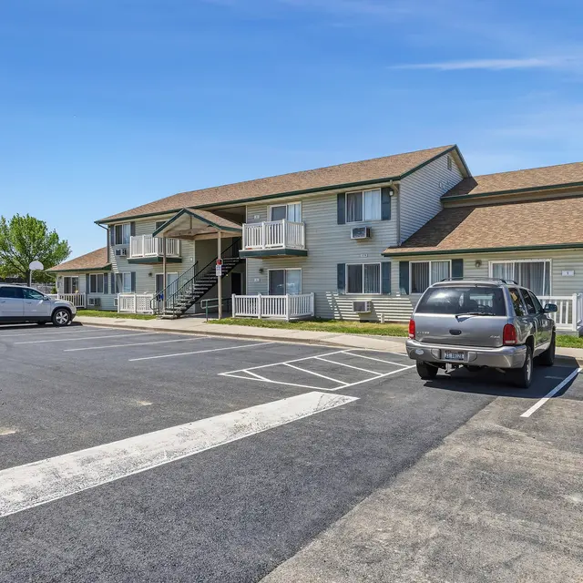 Apartment Complex and Parking Lot View of a two-story apartment complex with a parking lot in front.