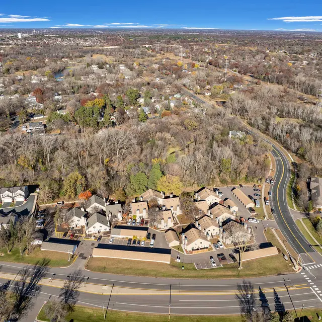 Aerial view of a residential neighborhood with a mix of trees and houses