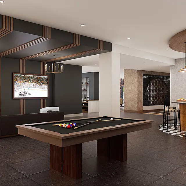 A spacious lounge area featuring a billiards table, modern furnishings, and an elegant bar. There are two large windows, a dark color scheme with wood accents, and stylish lighting fixtures.