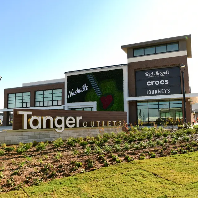 A clear view of the Tanger Outlets sign with shops including Crocs and Journeys, and a design element featuring the word 'Nashville.'