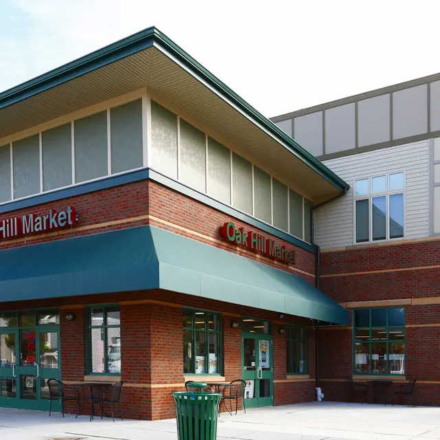 Exterior of Oak Hill Market Exterior view of Oak Hill Market, a modern brick building with large windows and an awning.