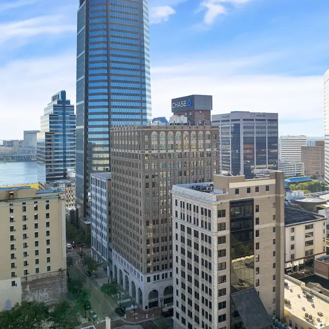 Downtown Jacksonville Skyline A panoramic view of downtown Jacksonville with various skyscrapers and the St. Johns River in the background.