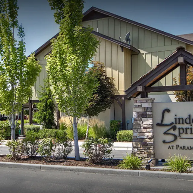 Exterior view of Linder Springs at Paramount, featuring a sign and landscaped surroundings.