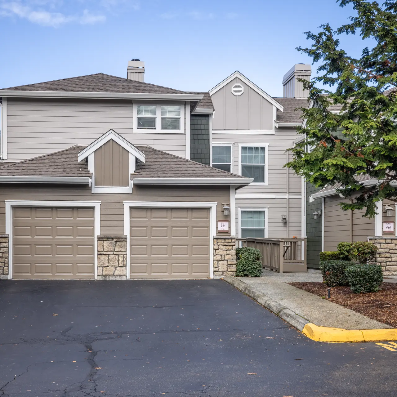 Front view of a two-story apartment complex with two garages