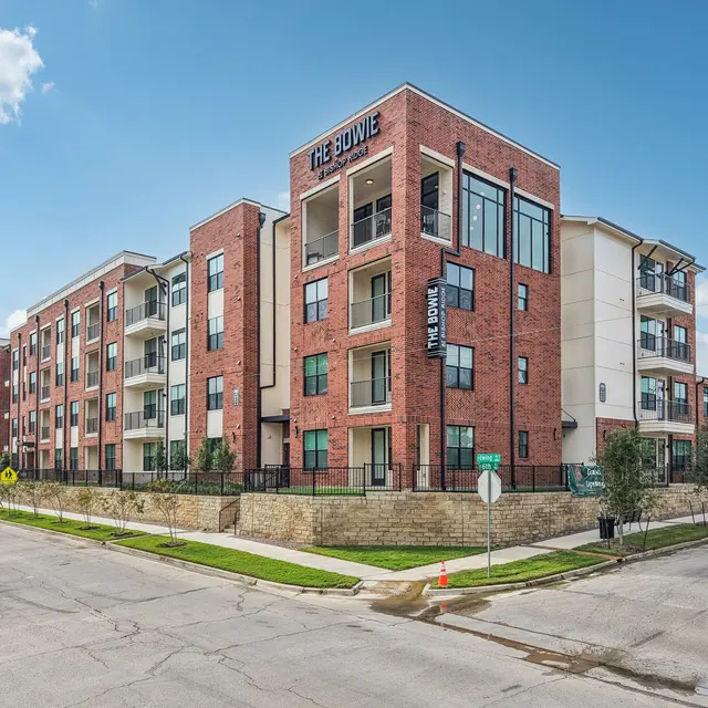 Exterior view of a modern apartment complex named 'The Bowie', showcasing brick construction and contemporary design.