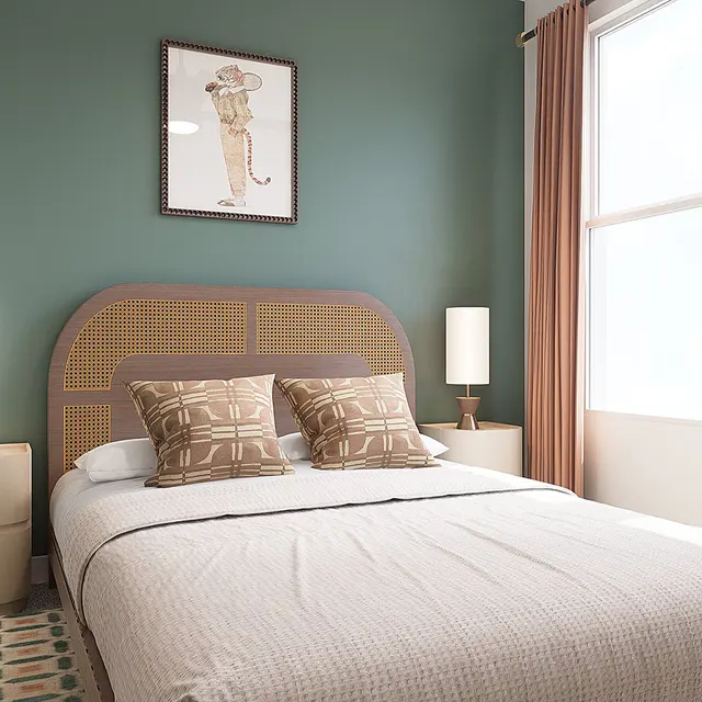 A modern bedroom featuring a double bed with decorative pillows, side lamps on nightstands, and large windows letting in natural light. The wall behind the bed is painted green, and a framed artwork hangs above it. Curtains on the windows add a cozy touch.