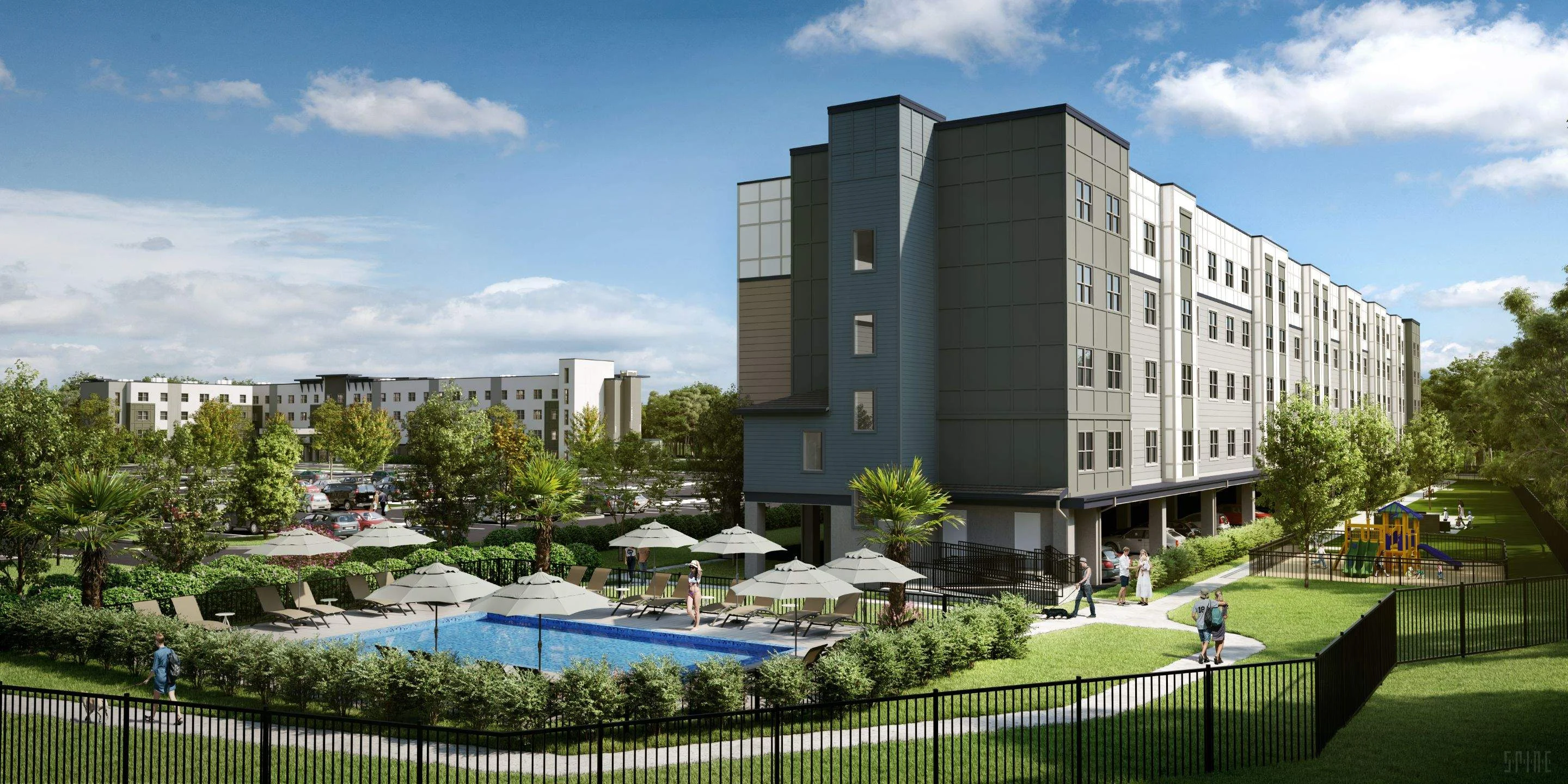 A modern apartment complex with a pool and landscaped grounds on a sunny day.