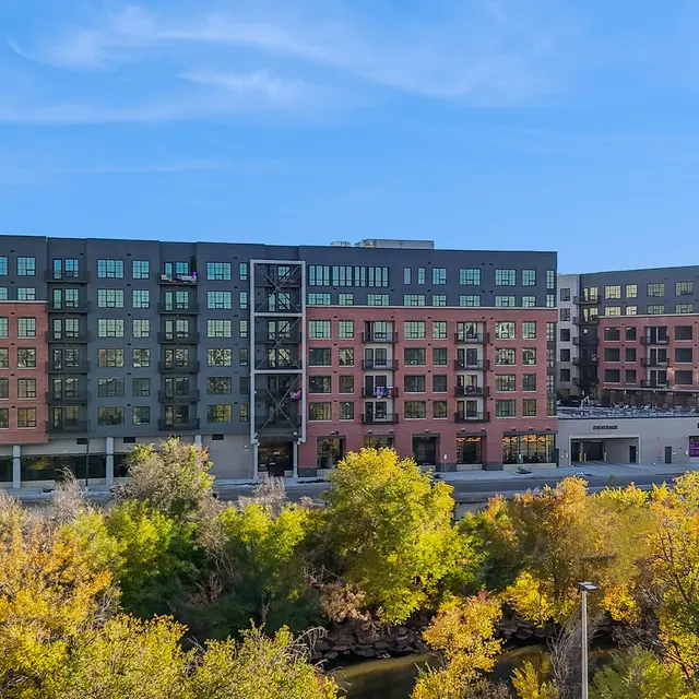 Modern Apartment Complex View of modern apartment buildings surrounded by greenery and blue sky