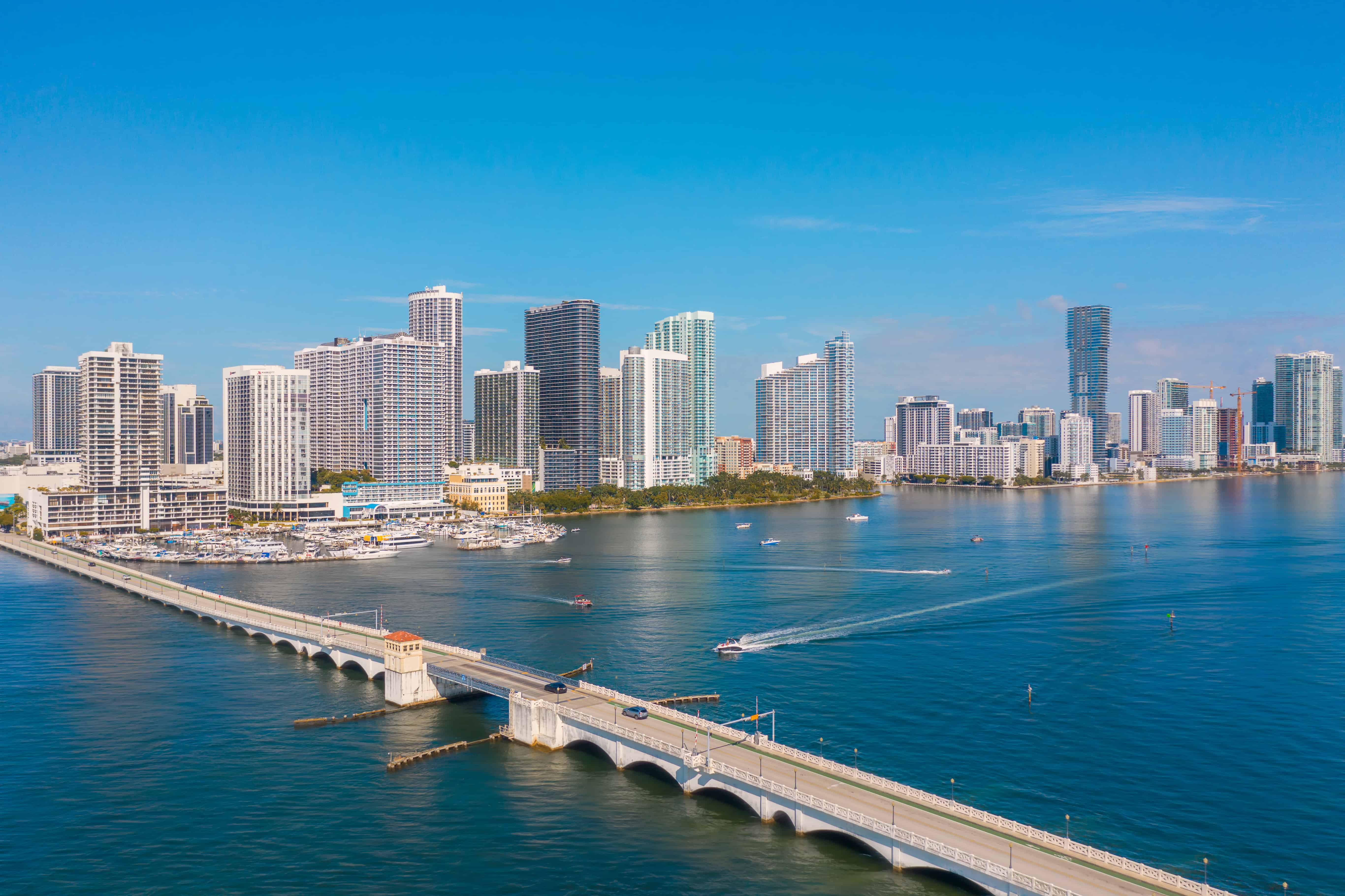 Miami Cityscape Aerial View Aerial view of a cityscape in Miami featuring tall modern buildings along a waterfront with a bridge in the foreground.